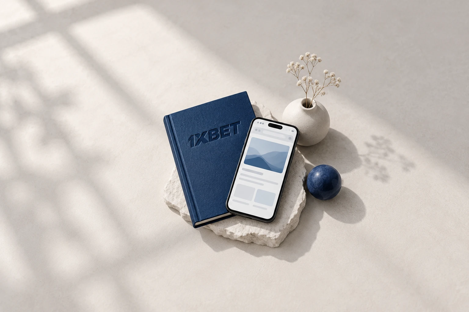 Un téléphone présentant un navigateur abstrait repose contre une reliure bleue marquée 1XBET.